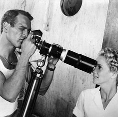 a man and woman looking through a telescope