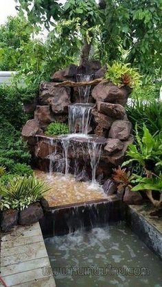 a small waterfall in the middle of a garden