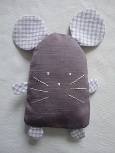 a gray cat pillow with ears and eyes