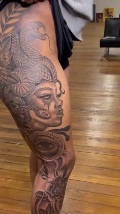 a woman's leg with tattoos on it