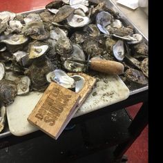 a tray filled with lots of clams on top of a table