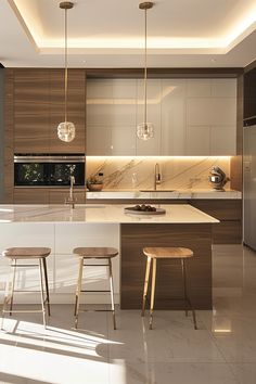 a kitchen with two stools in front of an island and lights on the ceiling