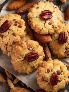 several cookies with pecans and almonds on top