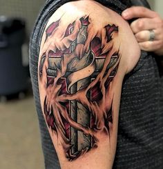 a man's arm with a cross and flames tattoo design on the upper half of his arm