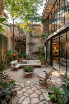 an outdoor living room with lots of plants and furniture