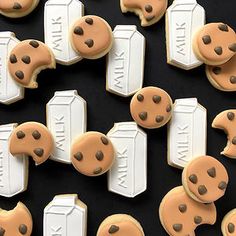 cookies with chocolate chips in the shape of doors and windows are arranged on a black surface