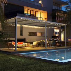 a house with a swimming pool in the yard at night, lit up by string lights