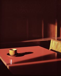 a table with a cup on it in a room