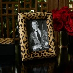 an animal print frame with a photo of a woman wearing a suit and tie on it