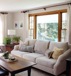 a living room filled with furniture and windows