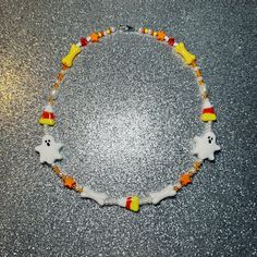 Our Candy Corn Ghost Necklace is the perfect accessory for spooky season, trick or treating, halloween parties, party favors, gifts, and more  Each necklace is one of a kind and made with love (beads and colors may vary). Care Instructions: Jewelry is handmade so please handle with care and keep away from water to avoid damage! Also avoid tugging / pulling on the necklace as it is handmade and fragile.  halloween, ghost, spooky, party, gift, mismatch necklace, customizable, halloween accessory, beaded necklace, cute beaded jewelry, trendy jewelry, y2k, beads, kid friendly jewelry, kids beads, kids birthday, costume Cute Beaded Jewelry, Y2k Beads, Ghost Necklace, Trick Or Treat Costume, Birthday Costume, Jewelry Y2k, Jewelry Kids, Necklace Y2k, Spooky Party