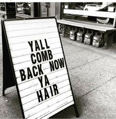 a black and white photo of a sign that says yal comb back now ya hair