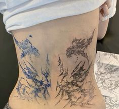 a woman's back with blue ink on it