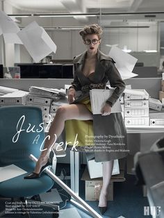 a woman sitting on top of a chair in an office