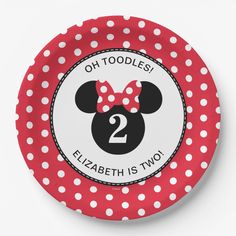 a red and white polka dot paper plate with minnie mouse's head on it