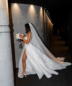 a woman in a wedding dress is walking down the aisle