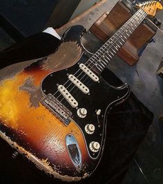 an old guitar sitting on top of a table