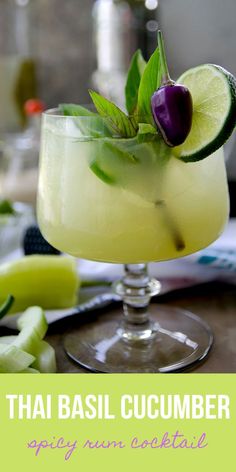 a drink with lime, cucumber and an olive garnish