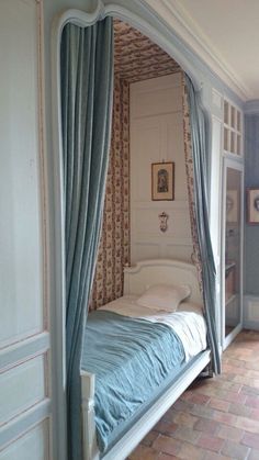 a bedroom with a canopy bed in the corner