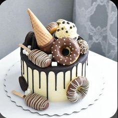 there is a cake that has ice cream, donuts and chocolate icing on it