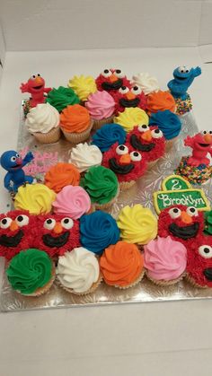 the cupcakes are decorated with colorful icing and sesame street characters on them