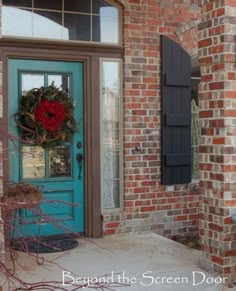 a blue front door with a wreath on it