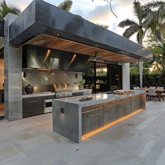 an outdoor kitchen and dining area is shown