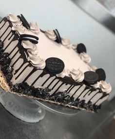 a cake with oreo cookies and cream frosting sitting on top of a table