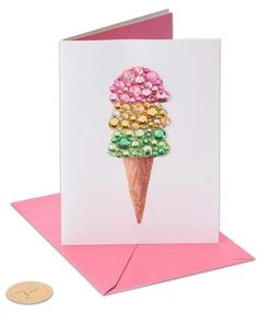 a card with an ice cream cone decorated with colorful candies on it's side