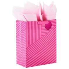 a pink shopping bag with tissue paper in it