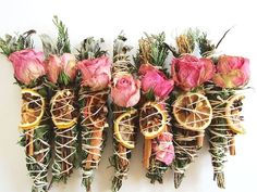 several dried flowers and oranges are arranged in a row