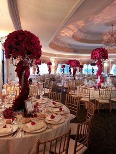 the tables are set with white and red flowers