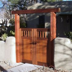 a wooden gate in front of a house