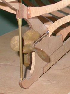 a close up of a wooden chair with metal handles