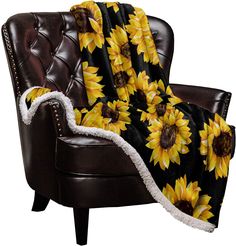 a chair with a sunflower blanket on it