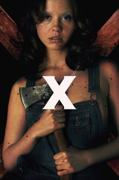 a woman in overalls holding an ax