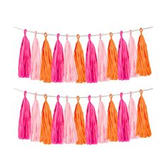 pink and orange tasselled garlands hanging from a string on a white background