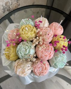 a bouquet of flowers sitting on top of a glass table