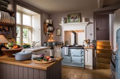 a kitchen filled with lots of appliances and counter top space next to a window covered in pots and pans