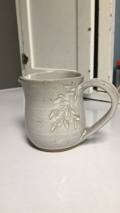 a white mug sitting on top of a counter