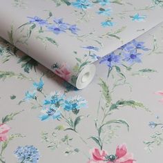 a floral wallpaper with pink, blue and green flowers on it's side