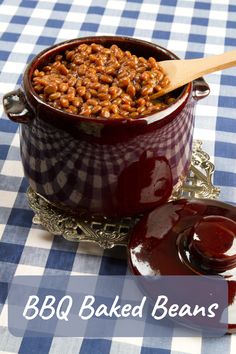 baked beans with bbq sauce in a pot on a blue and white checkered tablecloth