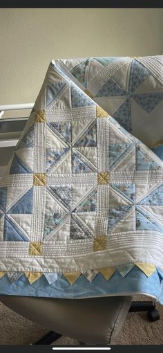 two quilted bedspreads sitting next to each other