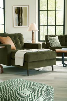 a living room filled with furniture and windows