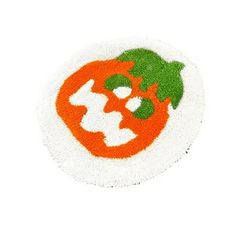 an orange and white patch with green leaves on the top, in front of a white background