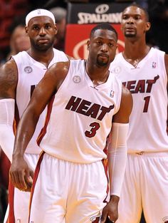 two miami heat basketball players standing next to each other