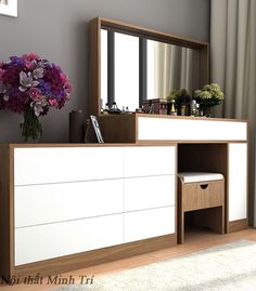 a white and brown dresser sitting next to a window with purple flowers in the vase