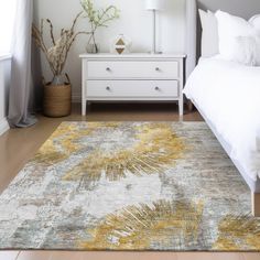 a white bed sitting next to a dresser in a bedroom