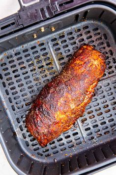 a piece of meat sitting on top of a grill