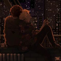 two people sitting on a ledge in the city at night